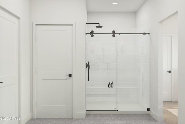 bathroom with tile patterned flooring and a shower with shower door