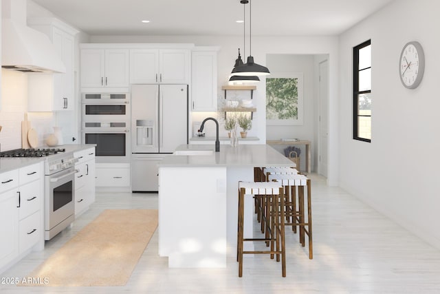 kitchen with sink, white cabinets, a kitchen island with sink, custom range hood, and white appliances