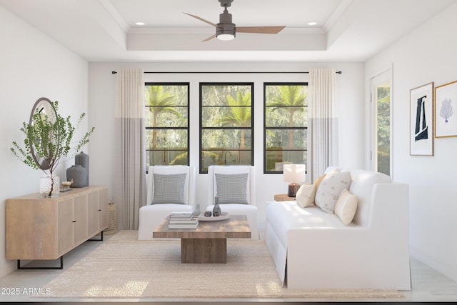 sitting room featuring a raised ceiling, a wealth of natural light, and light hardwood / wood-style flooring