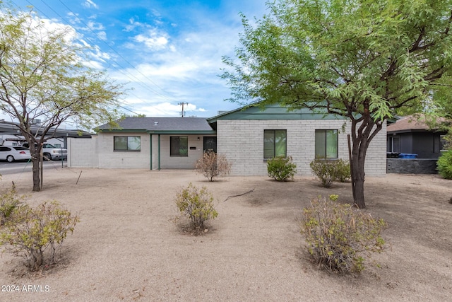 ranch-style house featuring brick siding