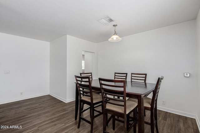 dining space with dark wood-type flooring