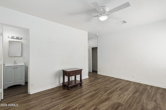 unfurnished bedroom with ceiling fan, a closet, ensuite bath, hardwood / wood-style flooring, and sink