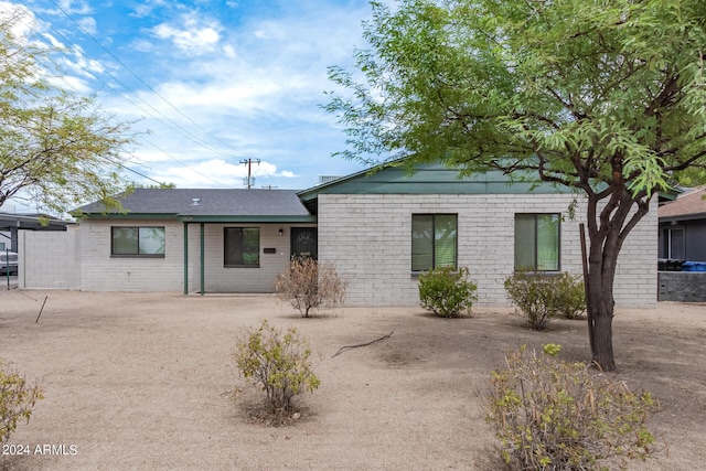 ranch-style house featuring brick siding