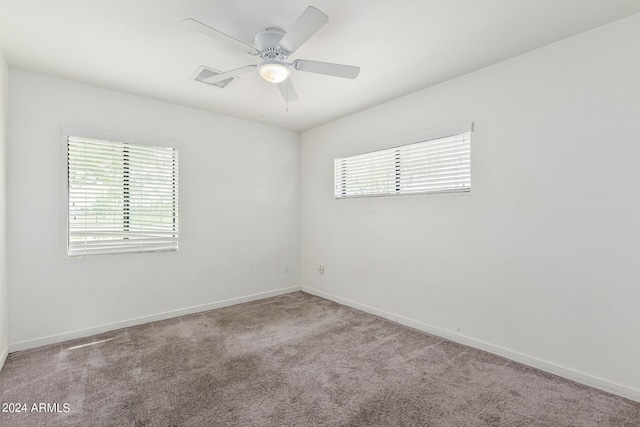 spare room with carpet floors and ceiling fan