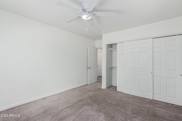 unfurnished bedroom with ceiling fan, carpet flooring, and a closet