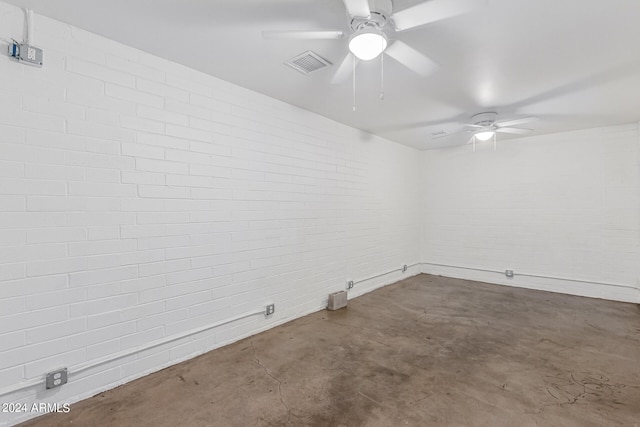 spare room with ceiling fan and concrete floors