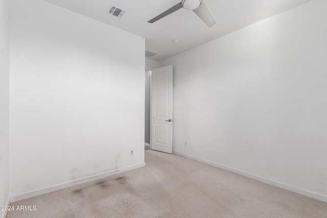 empty room with ceiling fan and light colored carpet