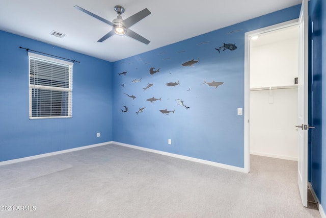 empty room with light colored carpet and ceiling fan