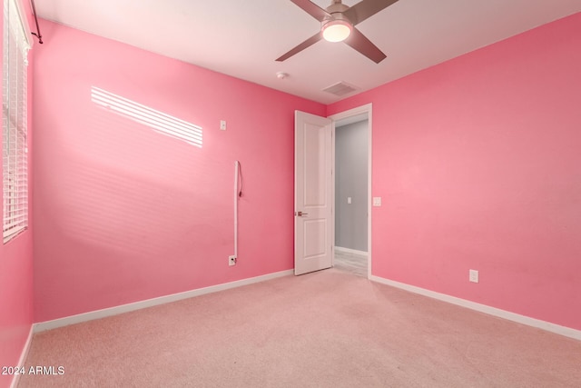 empty room with light carpet and ceiling fan