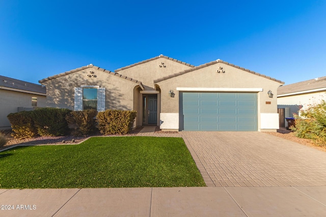 mediterranean / spanish home with a front yard and a garage