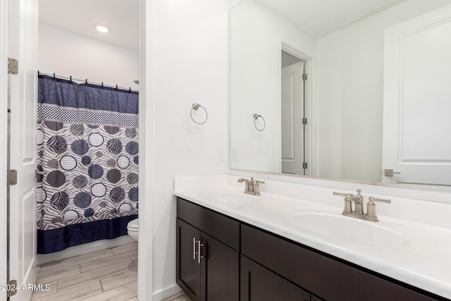 bathroom featuring a shower with curtain, vanity, and toilet