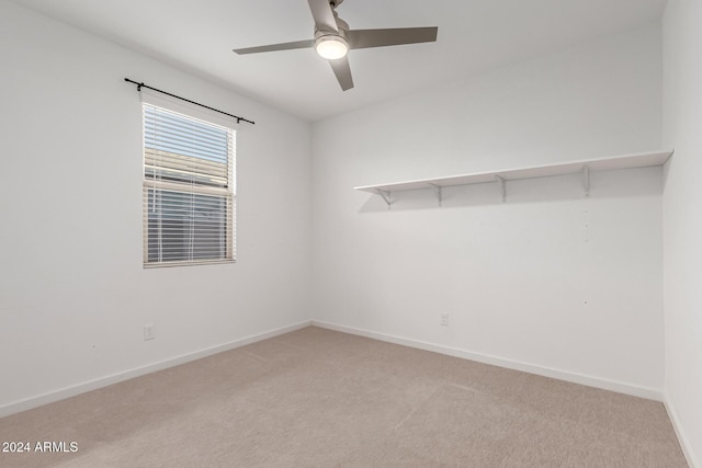 carpeted empty room featuring ceiling fan