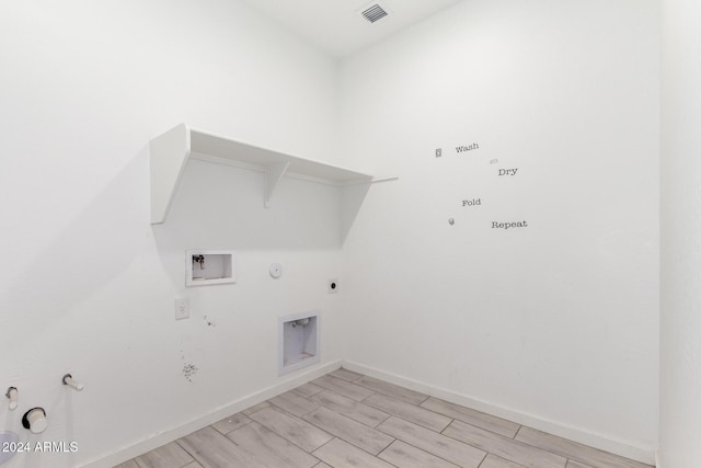 laundry area featuring light wood-type flooring, hookup for a washing machine, hookup for an electric dryer, and gas dryer hookup