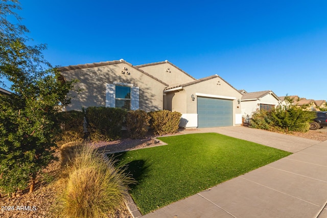 view of front of property with a garage and a front lawn