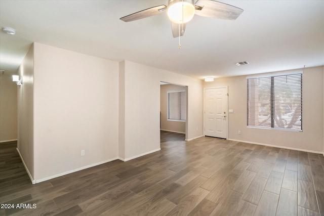 empty room featuring dark hardwood / wood-style flooring and ceiling fan