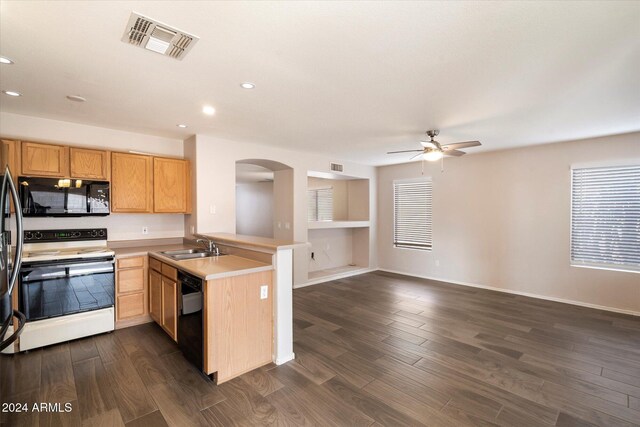 kitchen with kitchen peninsula, dark hardwood / wood-style floors, ceiling fan, and black appliances