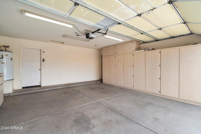 garage featuring a garage door opener and water heater