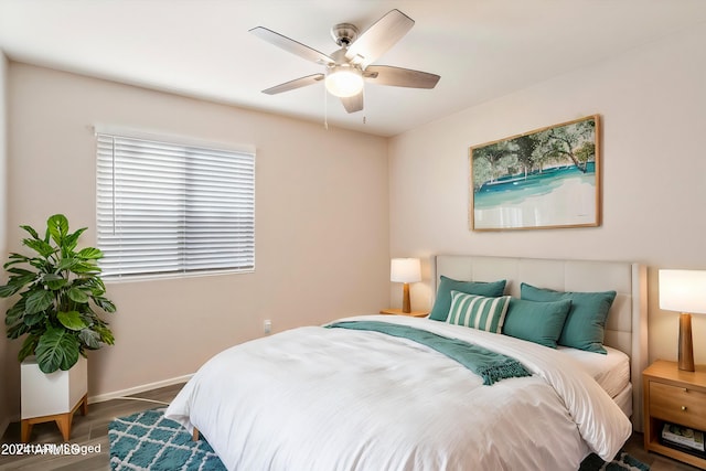 bedroom with dark hardwood / wood-style floors and ceiling fan