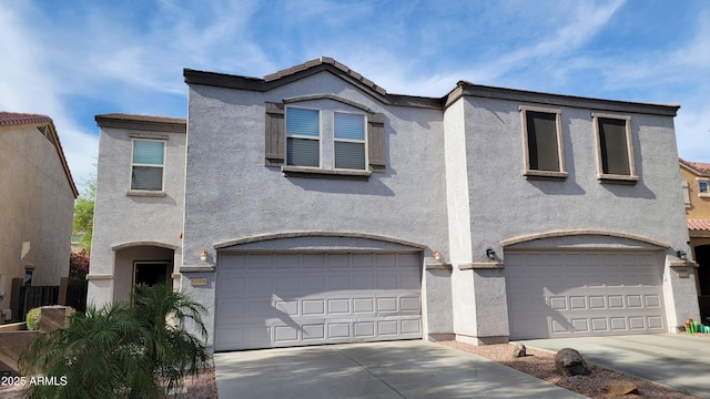 8854 W Aster Dr, Peoria, AZ 85381 - view of front of home with a garage, stucco siding, and driveway