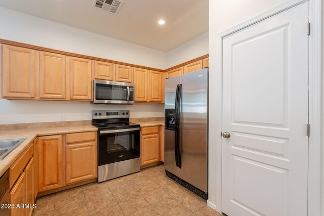 8854 W Aster Dr, Peoria, AZ 85381 - kitchen with stainless steel appliances, light countertops, recessed lighting, light tile patterned flooring, and a sink