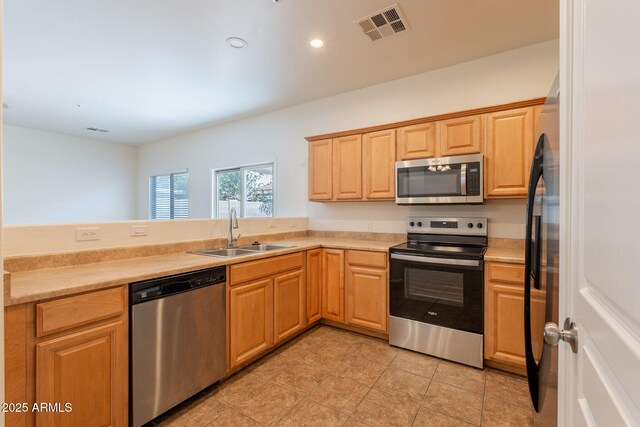 8854 W Aster Dr, Peoria, AZ 85381 - kitchen featuring stainless steel appliances, a sink, light countertops, recessed lighting, and light tile patterned floors