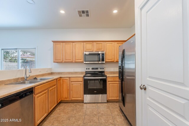 8854 W Aster Dr, Peoria, AZ 85381 - kitchen with stainless steel appliances, a sink, light countertops, light brown cabinetry, and light tile patterned floors