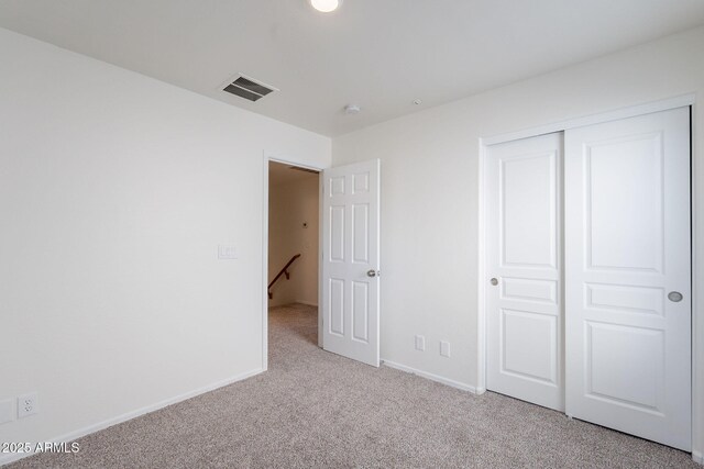 8854 W Aster Dr, Peoria, AZ 85381 - unfurnished bedroom featuring light carpet, baseboards, and a closet