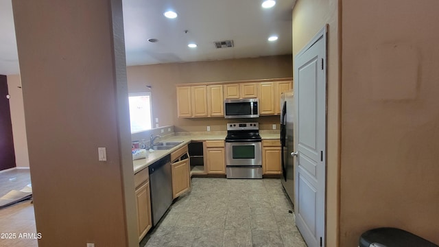 8854 W Aster Dr, Peoria, AZ 85381 - kitchen with appliances with stainless steel finishes, light countertops, light brown cabinetry, a sink, and recessed lighting