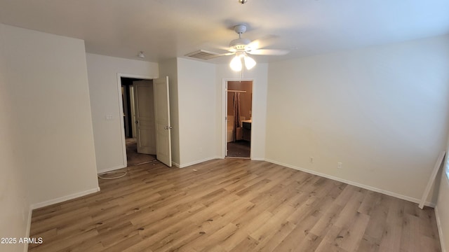 8854 W Aster Dr, Peoria, AZ 85381 - empty room with light wood finished floors, ceiling fan, and baseboards
