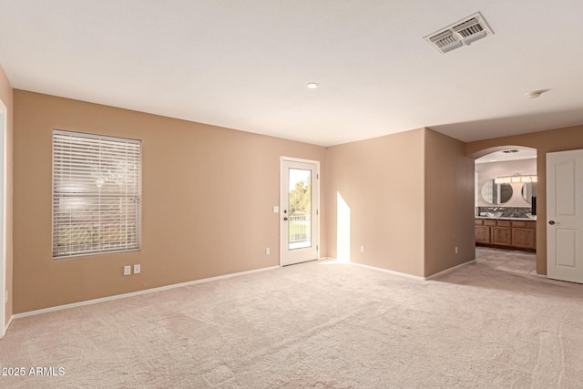 unfurnished room with light colored carpet