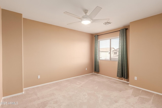 empty room with ceiling fan and light carpet