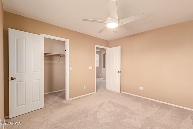 unfurnished bedroom featuring light carpet, a closet, and ceiling fan