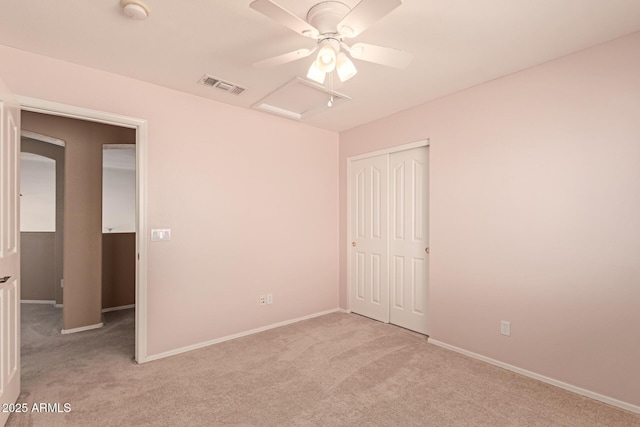 unfurnished bedroom featuring light colored carpet, a closet, and ceiling fan