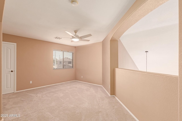 unfurnished room with light carpet and ceiling fan