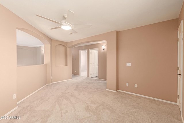 empty room featuring light colored carpet and ceiling fan