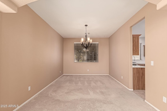 unfurnished dining area with an inviting chandelier and light carpet