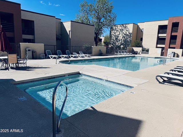 community pool featuring fence and a patio