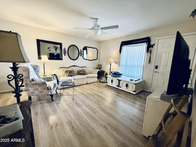 living room featuring ceiling fan and wood finished floors