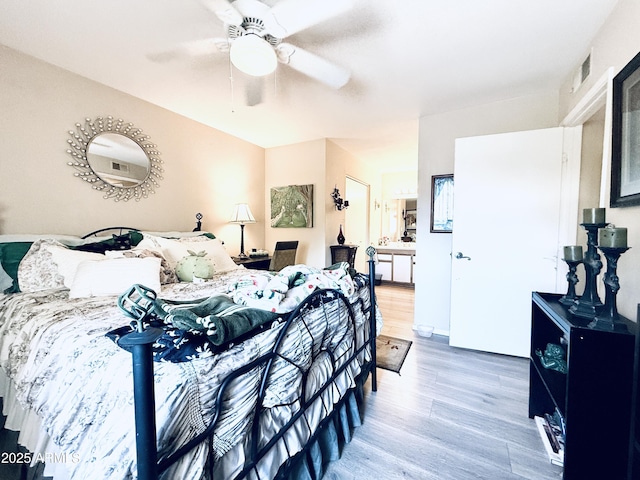 bedroom with a ceiling fan, visible vents, and light wood-style floors