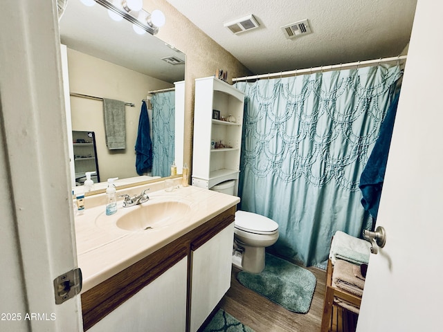 full bath with visible vents, a textured ceiling, and wood finished floors