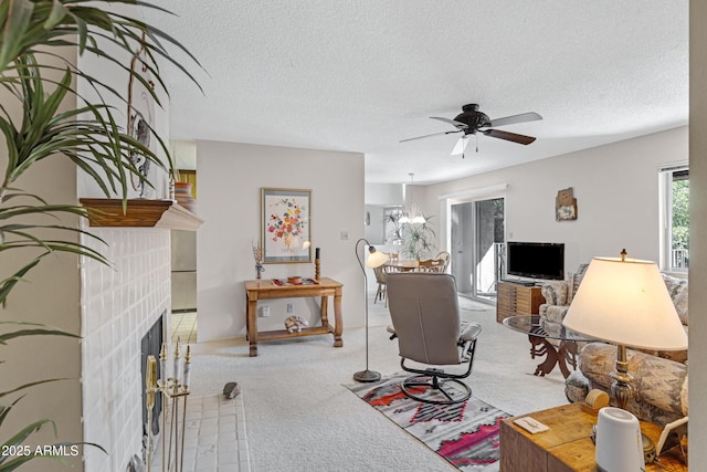 living room featuring ceiling fan, a textured ceiling, and carpet flooring