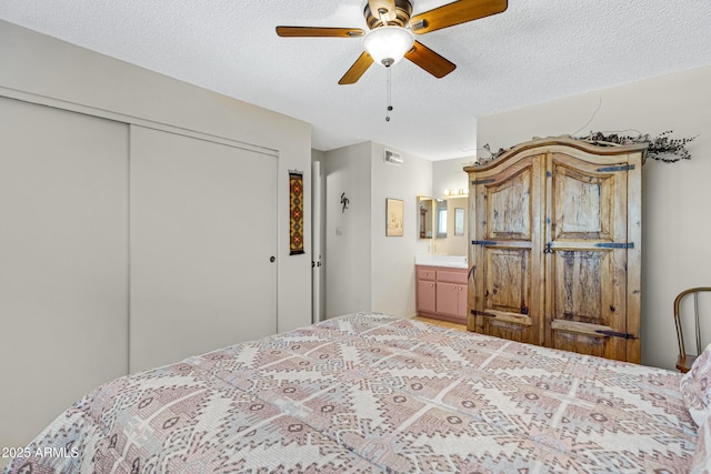 bedroom with ceiling fan, a closet, and a textured ceiling