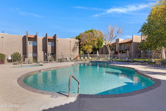 view of pool featuring a hot tub and a patio