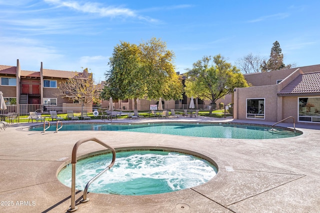 view of pool with a community hot tub and a patio area