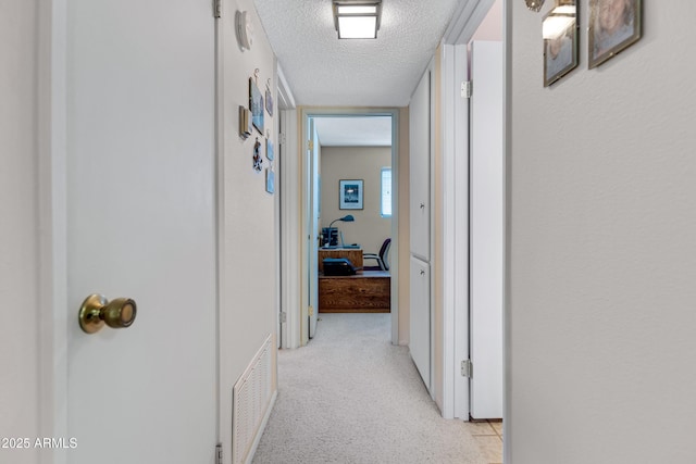 hallway with a textured ceiling