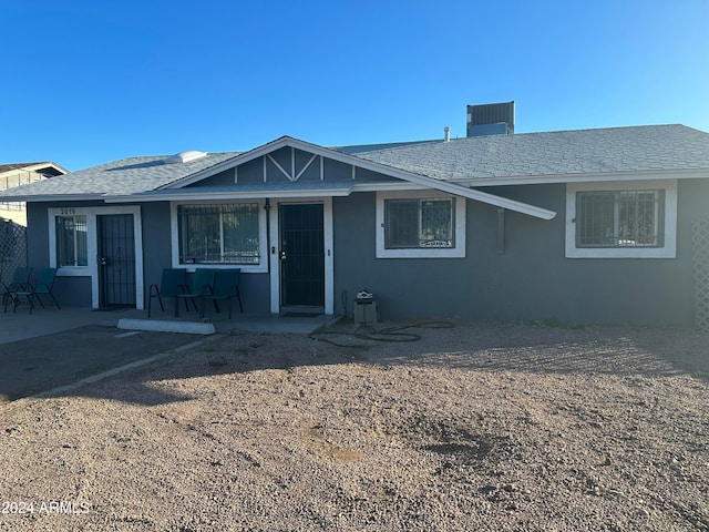 view of front of house with a patio and central AC