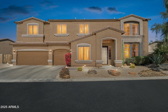 4502 E Night Owl Ln, Cave Creek, AZ 85331 - mediterranean / spanish home featuring concrete driveway, a tile roof, an attached garage, and stucco siding