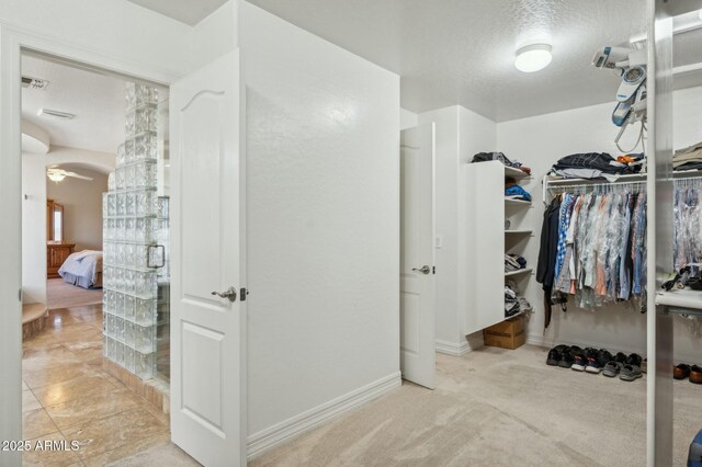 4502 E Night Owl Ln, Cave Creek, AZ 85331 - spacious closet featuring visible vents, ceiling fan, and light carpet