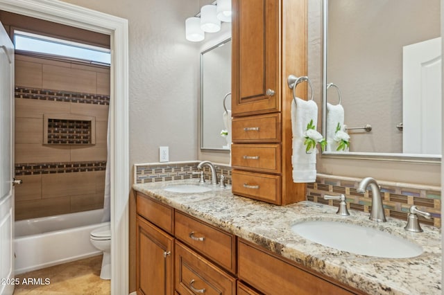 4502 E Night Owl Ln, Cave Creek, AZ 85331 - bathroom with toilet, a sink, decorative backsplash, and bathtub / shower combination