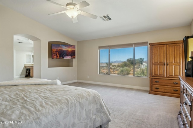4502 E Night Owl Ln, Cave Creek, AZ 85331 - bedroom featuring arched walkways, lofted ceiling, visible vents, light carpet, and baseboards